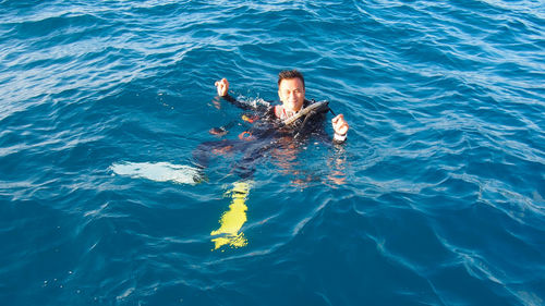 Portrait of smiling man swimming in sea