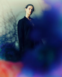 Young man standing against wall