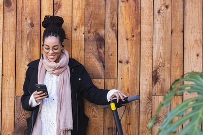 Full length of young woman using mobile phone