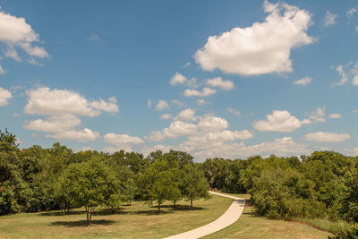 Road amidst trees against sky