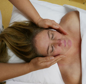 High angle view of woman having reiki treatment at spa