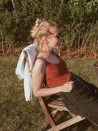 Young woman sitting on field