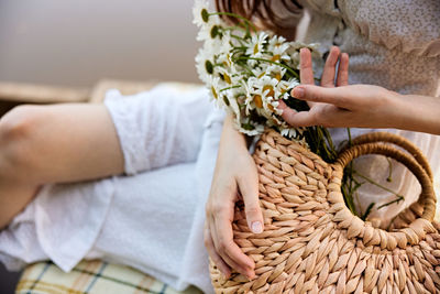 Midsection of woman holding flower