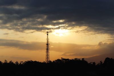 Low angle view of silhouette tower against sky during sunset