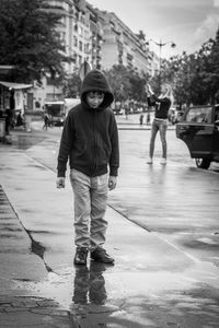 Full length portrait of boy walking on street