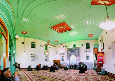 People sitting in corridor of building