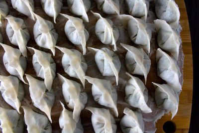 High angle view of chinese dumplings on cutting board