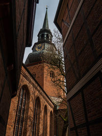 Low angle view of clock tower against sky