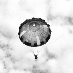Low angle view of people against cloudy sky