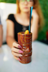 Close-up of hand holding drink