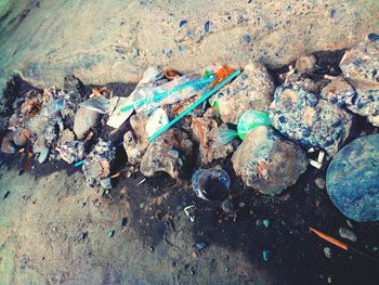 High angle view of garbage on rock