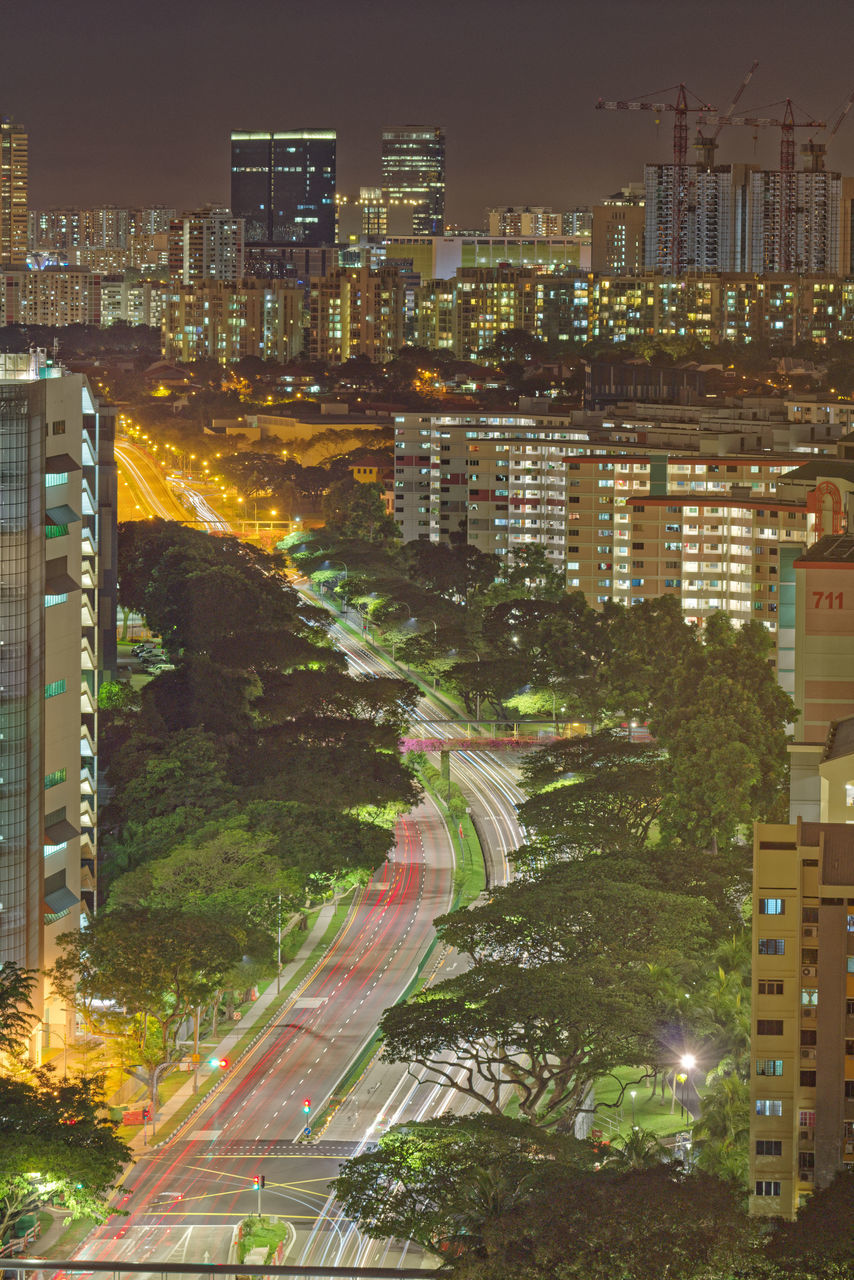 city, building exterior, architecture, built structure, illuminated, building, street, transportation, cityscape, road, night, no people, nature, high angle view, outdoors, sky, city life, residential district, modern, plant, office building exterior, skyscraper