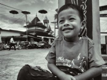 Portrait of boy sitting at amusement park