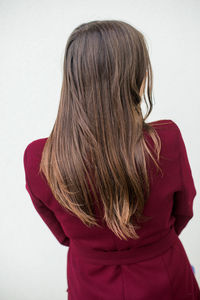 Rear view of woman against white background