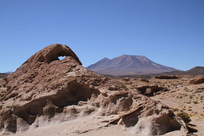 Scenic view of volcanic mountain against clear sky