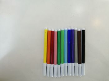 Close-up of colored pencils against white background