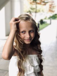 Portrait of smiling girl standing outdoors