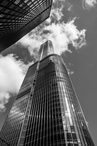 Low angle view of modern building against cloudy sky