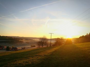 Scenic view of field against sky during sunset