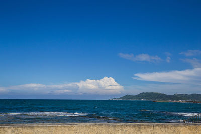Scenic view of sea against blue sky