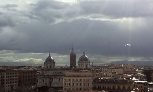 View of cityscape against cloudy sky