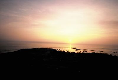 Scenic view of sea against romantic sky at sunset