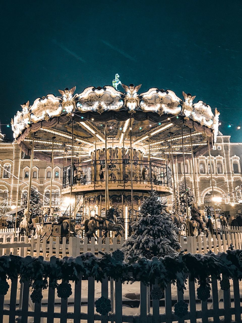 LOW ANGLE VIEW OF ILLUMINATED AMUSEMENT PARK AT NIGHT