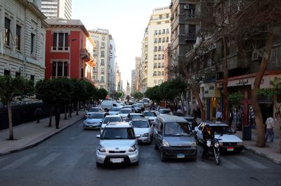 Cars on street amidst buildings in city