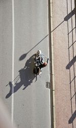 High angle view of man riding motorcycle on road