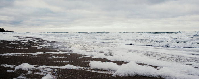 Scenic view of snow covered land against sky