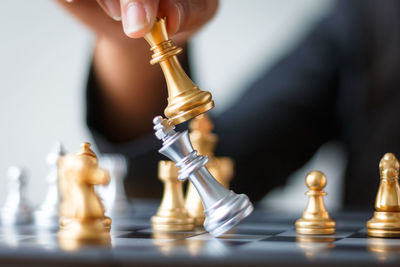 Cropped image of hand playing chess