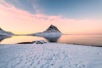 Scenic view of frozen sea against sky during sunset