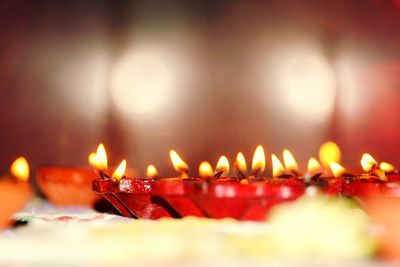 Close-up of illuminated red diya