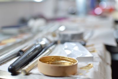 Close-up of lid and make-up brush on table