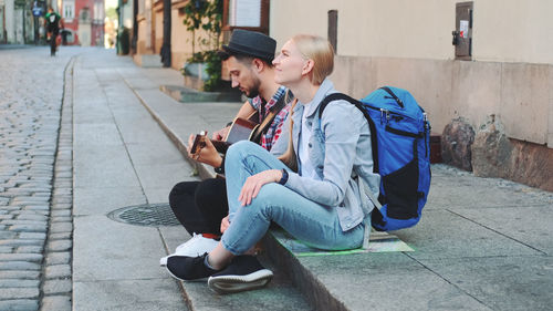 People sitting on footpath