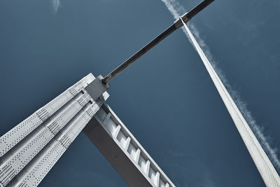 Low angle view of crane against sky
