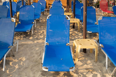 High angle view of empty chairs against blue sky