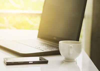 Close-up of coffee cup on table