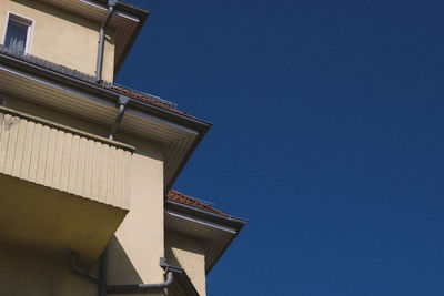 Low angle view of building against clear blue sky