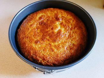 Freshly baked banana bread in a cake pan.