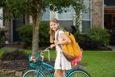 Young woman riding bicycle on footpath