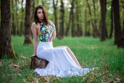 Young woman on field in forest