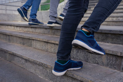 Low section of people walking on staircase