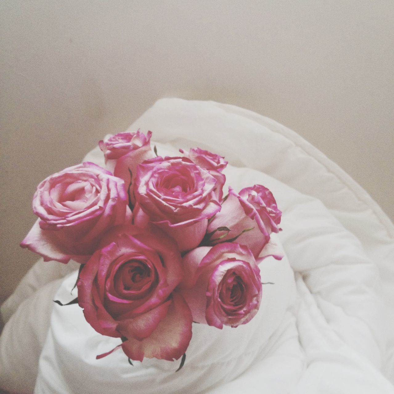 flower, rose - flower, indoors, petal, freshness, pink color, rose, flower head, fragility, close-up, red, bouquet, pink, high angle view, beauty in nature, table, home interior, white color, softness, no people