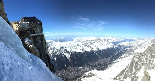 Scenic view of snowcapped mountains against blue sky