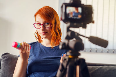 Portrait of woman photographing