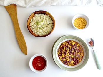 High angle view of beans and corns in bowl on table