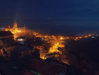 High angle view of illuminated buildings in city at night