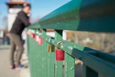 Love locks hanging on railing at bridge