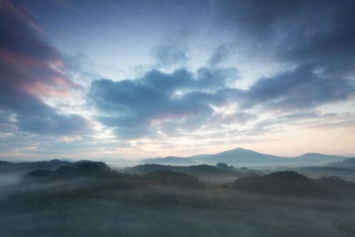 Scenic view of silhouette mountains against sky during sunset